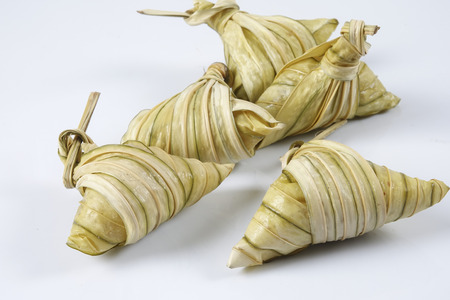 Malay dish ketupat daun palas or rice dumpling where glutinous rice is wrapped in a triangular shape using the leaves of the fan palmの写真素材