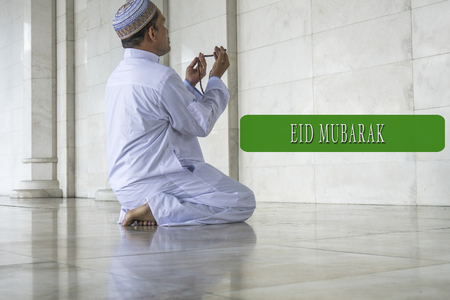 EID MUBARAK concepts word with background of muslim model.