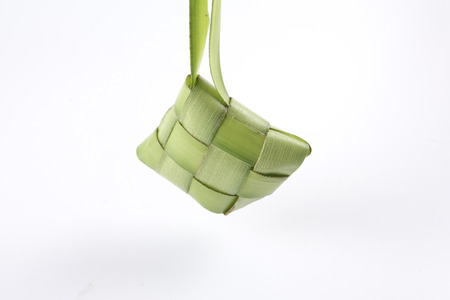 Making of Ketupat, a natural rice casing made from young coconut leaves for cooking riceの写真素材