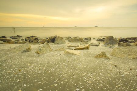 Scenery of sunset captured at Pantai Remis, Selangor, Malaysia. The motion of cloud and water is due to long exposure effect. Low lightの写真素材
