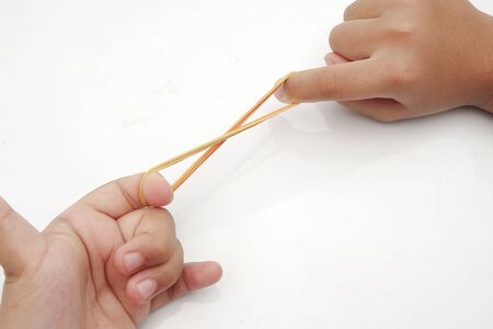Elastic rubber band on hands, isolated on white