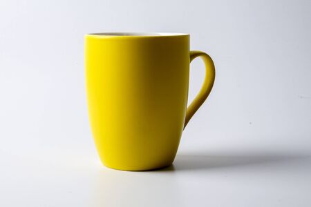 Colored mug isolated on whiteの写真素材