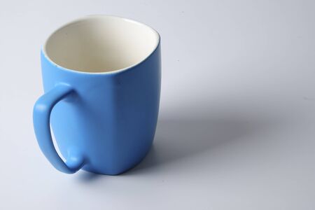 Colored mug isolated on whiteの写真素材