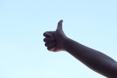 Child's thumb up.