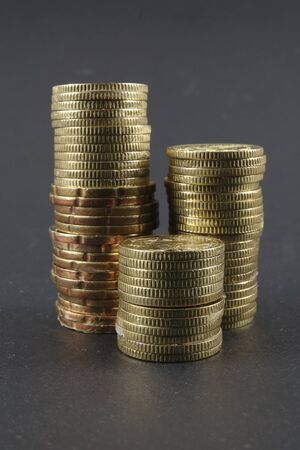 Stack of coins on black.の写真素材