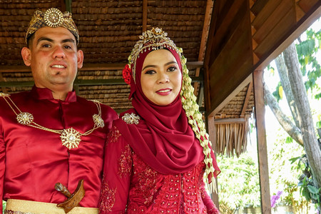 Traditional javanese wedding couple bride and bridegroom at gardenの写真素材