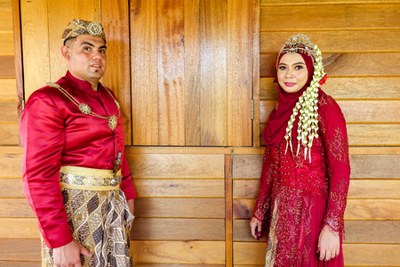 Traditional javanese wedding couple bride and bridegroom at gardenの写真素材