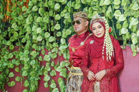 Traditional javanese wedding couple bride and bridegroom at gardenの写真素材