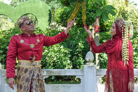 Traditional javanese wedding couple bride and bridegroom at gardenの写真素材