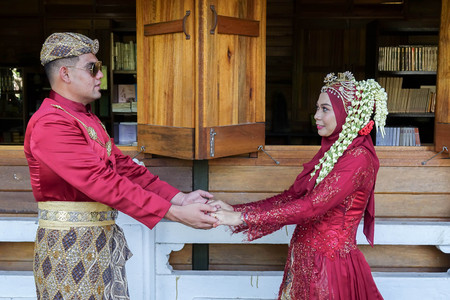 Traditional javanese wedding couple bride and bridegroom at gardenの写真素材