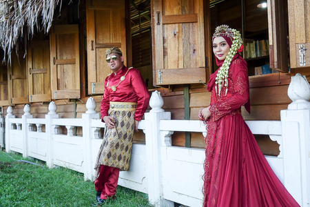 Traditional javanese wedding couple bride and bridegroom at gardenの写真素材