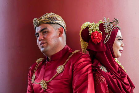 Traditional javanese wedding couple bride and bridegroom at gardenの写真素材