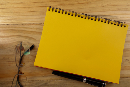 Office wooden desk table with laptop and coffee cup. Top view with copy spaceの写真素材