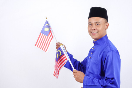 Asian young man with Malaysia flag for National Day celebration.の写真素材