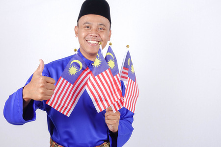 Asian young man with Malaysia flag for National Day celebration.の写真素材