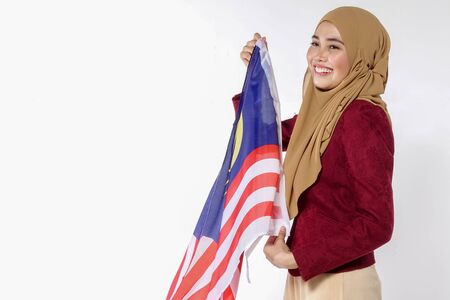 Young beutiful lady holds Malaysia flag isoleted on whitebackground.の写真素材