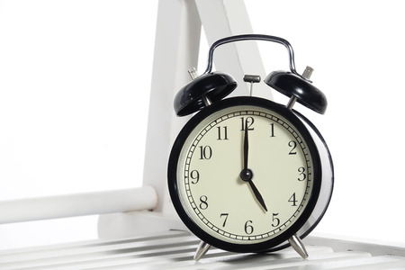 Black alarm clock isolated on white.