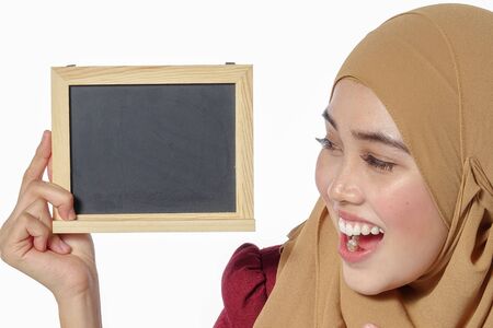 Pretty young Asian lady holds chalkboard.の写真素材