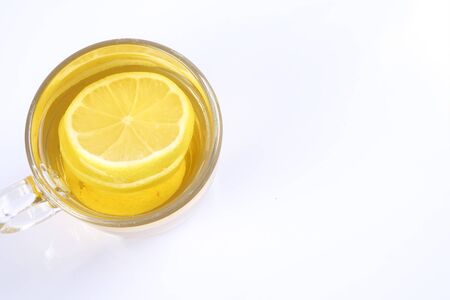 Hot lemon tea in the glass on white background.の写真素材