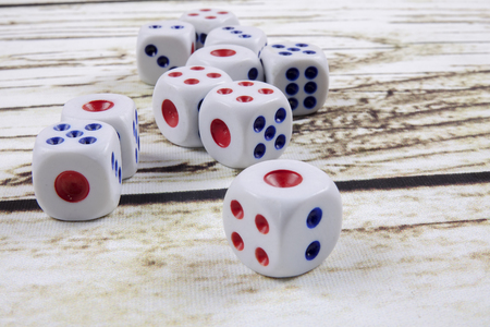 White dice on wooden background.  Concept of luck, chance and leisure fun.