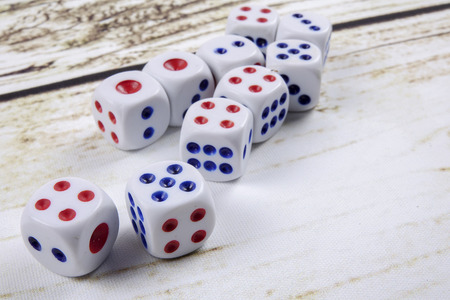 White dice on wooden background.  Concept of luck, chance and leisure fun.