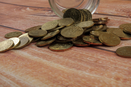Coins in the bottle on wooden background,saving money and business concept