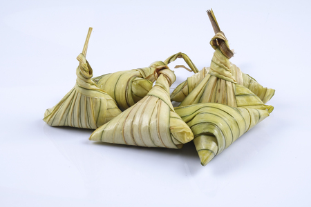Ketupat (Rice Dumpling) On white Background. Ketupat is a natural rice casing made from young coconut leaves for cooking rice during eid Mubarakの写真素材
