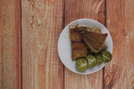 Salted fish with lime on wooden background.の写真素材