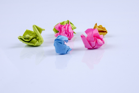 Colourful crumpled paper ball on a whiteboard. Close up.の写真素材