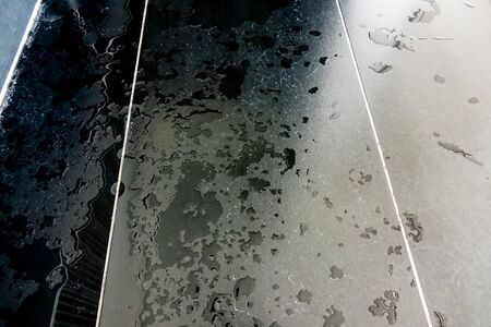 Wet black tile flooring