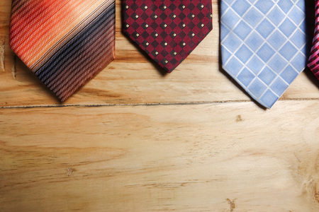 Colorful neckties isolated on wooden  background.の写真素材