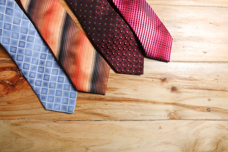 Colorful neckties isolated on wooden  background.の写真素材