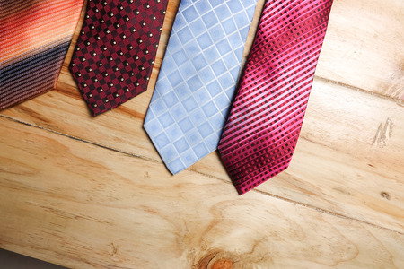 Colorful neckties isolated on wooden  background.の写真素材