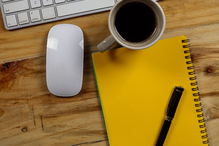 Office desk table with laptop computer and coffee cup . Top viewの写真素材