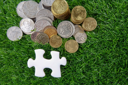 White missing jigsaw puzzle on the green background.の写真素材