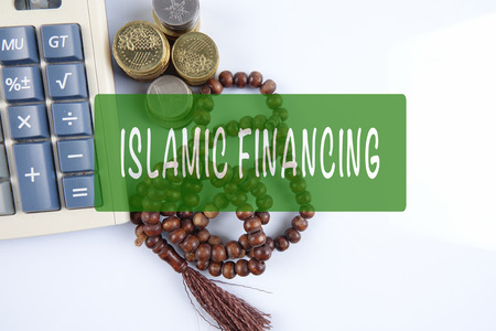 Rosary ,coins and calculator with ISLAMIC FINANCING words. Islamic business finance concept.の写真素材