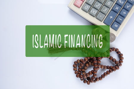 Rosary ,coins and calculator with ISLAMIC FINANCING words. Islamic business finance concept.の写真素材