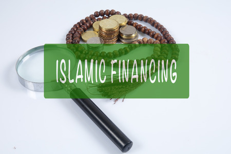 Rosary ,coins and calculator with ISLAMIC FINANCING words. Islamic business finance concept.の写真素材