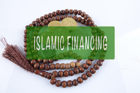 Rosary ,coins and calculator with ISLAMIC FINANCING words. Islamic business finance concept.の写真素材