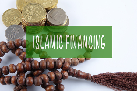 Rosary ,coins and calculator with ISLAMIC FINANCING words. Islamic business finance concept.の写真素材