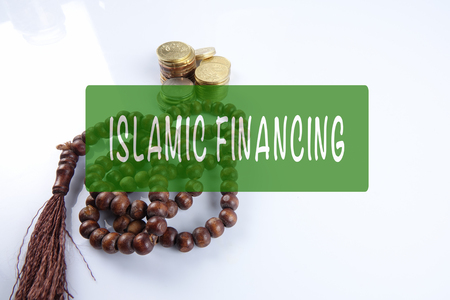 Rosary ,coins and calculator with ISLAMIC FINANCING words. Islamic business finance concept.の写真素材