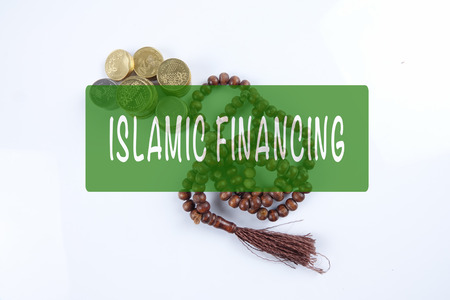 Rosary ,coins and calculator with ISLAMIC FINANCING words. Islamic business finance concept.