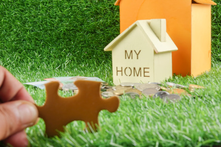 House on the green background. Housing/real estate concept.の写真素材