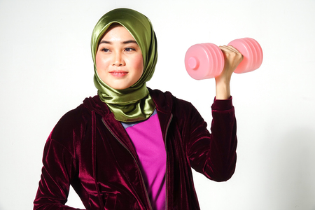 Young pretty asian girl exercise with dumbell and measuring tape. Diet healthy concept.の写真素材