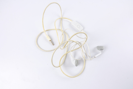 Obselete entangled earphones isolated on white.の写真素材