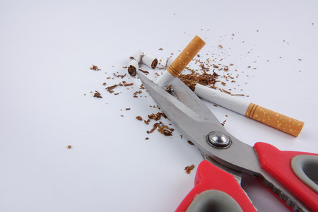 cigarettes and scissor isolated on white. Anti smoking conceptの写真素材