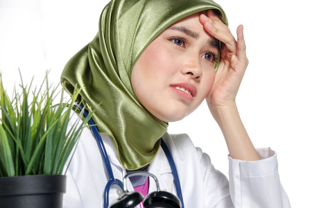 Stressful young doctor due to work overload and long working hours concept.の写真素材