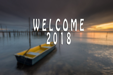 WELCOME 2018 text with the blurred landscape during sunset.の写真素材