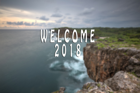 WELCOME 2018 text with the blurred landscape during sunset.の写真素材