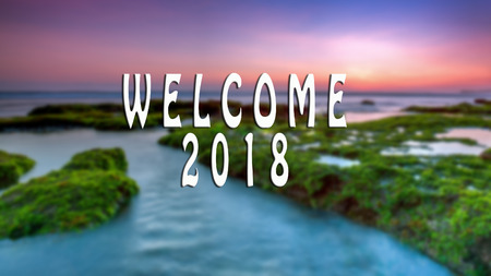 WELCOME 2018 text with the blurred landscape during sunset.の写真素材